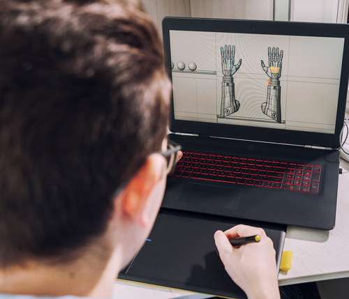 person working at a laptop designing robotic hands with 3D modeling software